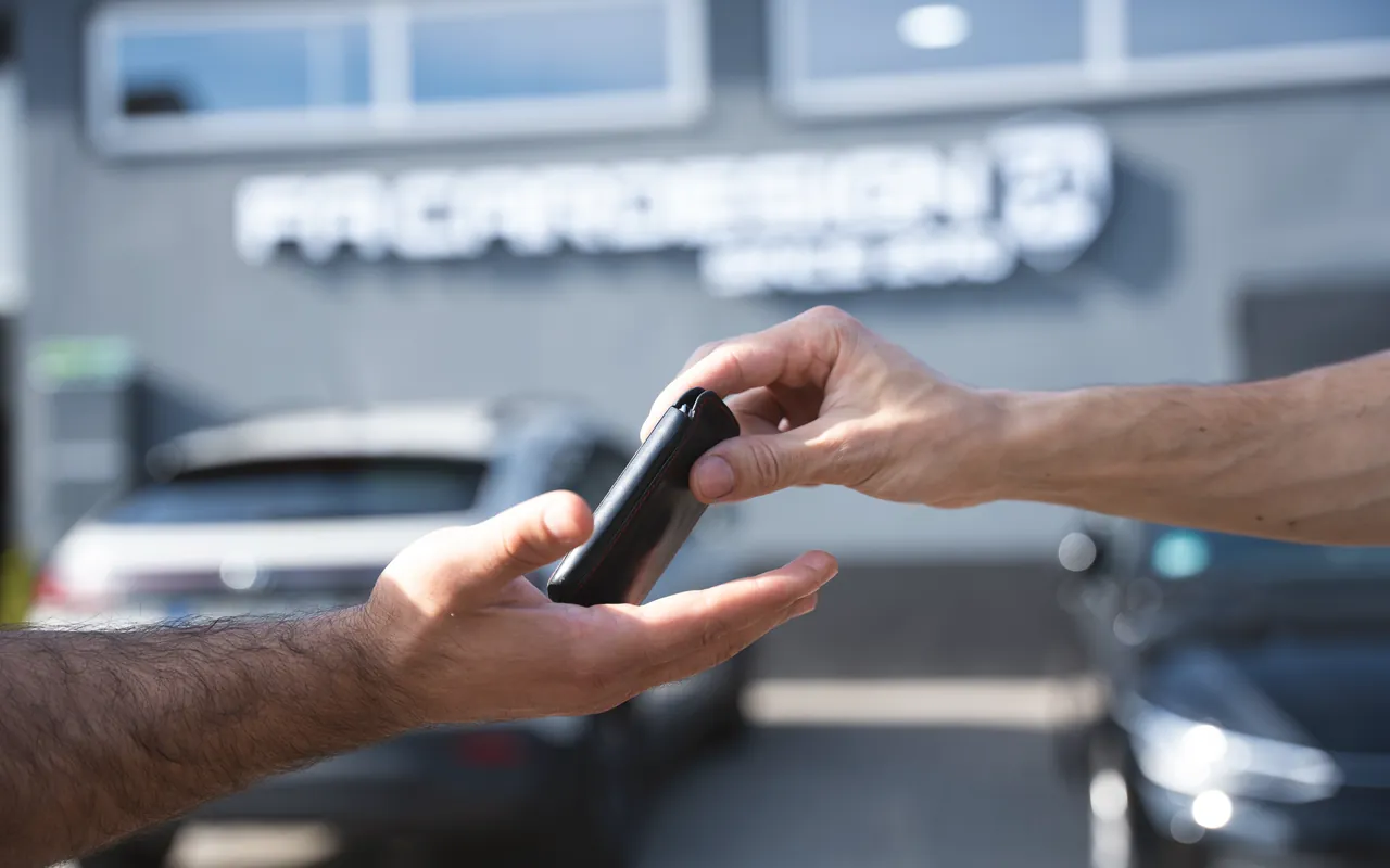 Übergabe des Fahrzeugschlüssels von Hand zu Hand bei FA-CARSERVICES